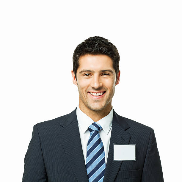 handsome young man posing with a name tag. square shot. isolated on white.